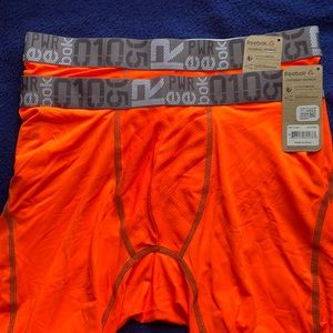 Reebok men’s medium trunks (2) Orange.        F